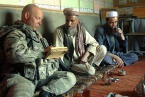 A member of a Human Terrain System team talks with local school administrators in Nani, Afghanistan